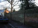 High wall outside the Rectory. House on left has frost on the roof.