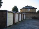 Row of garages.
The Cottage visible over the wall.