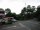 Road junction: Institute Road on the left, Station Road in the centre, Approach Road on the right.
Station Garage Taplow buildings and forecourt on left.
Group of Scots Pine trees on far side of junction, with cellphone tower.
