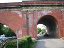 Brunel's famous brick railway bridge across the Thames.
The Sounding Arch on the left with boat passing underneath.
River Road passing through the right-hand arch.
Hedges and footpath sign in the foreground.