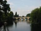 Maidenhead Bridge and the River Thames.
Dark trees on each side.
Moored boat on the left.
