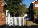 Corner of The Old Reading Room on the left.
White paling fence and gate.
Driveway to garage and house on far right.