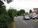 Looking north on Station Road.
Trees on left.
SGT car dealership on right.
Road junction in the background.