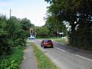 Looking north on Marsh Lane.
Footpath and bushes on left.
Traffic lights at junction with A4 Bath Road.
50 MPH speed limit sign.
Trees on right.