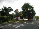 Road with Shell petrol station on far side.
Large trees.
Road sign giving directions to Maidenhead, Taplow, Bourne End.