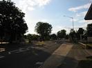 Looking west on the A4 Bath Road.
Large tree at entrance to petrol station on left.
Bus-stop and pub sign on right.