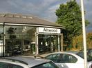 Altwood car showroom.
Large tree behind building.
Cars and lamp-post in foreground.