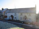 Cottages facing the Village Green.
Parked cars.
Frost on road and houses.