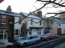 Houses on Rectory Road facing the Village Green.
Part of the Oak and Saw public house on the left.
Parked cars.
Frost on road and roofs.