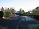 Looking East on Rectory Road.
Holly hedge around churchyard on the left.
Wellbank in the distance.
Frost on grass outside Priory Cottage.