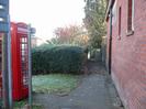 Footpath between St Nicolas House and Priory Cottage.
Red Telephone box on the left.
Public Footpath sign.
