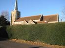St Nicolas Church, seen across neatly-clipped holly hedge
