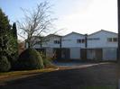 Eastern part of Wellbank.
Houses have white weatherboards on the upper level, and screen-walls built of decorative blocks on the ground floor.
Trees and clipped bushes on the left.