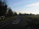 Looking South-East on Boundary Road.
SLOW and 30 road markings.
Boundary Road Stables fence on the left, with gas pipe markers.