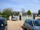 Car-park and garages, with houses behind.