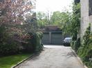 Road to garage block.
Side of 3 Cedar Chase on the right.
Judas Tree in flower on the left.