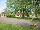 Road leading to St Nicolas School and Taplow Village Hall.
Stone tub of flowers.
Village Hall visible through trees.