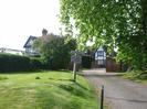 Driveway to Maryfield and Maryfield Cottage.
Grass on the left with house-name signs and Lilac bush.
Large Horse Chestnut tree on the right.
Houses in the background have black timbers and white paint.