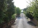 Road to Taplow Vineyard.
Granite chip road with low walls and trees on each side.