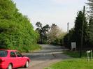 Looking South on Hill Farm Road.
Trees and parked car on the left.
Sign for Taplow Vineyard on the right.
Telephone poles and trees.