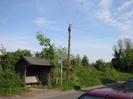 Bus shelter and telephone pole.
Bank with low plants.