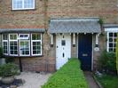 Houses 5 and 6.
Sandy-coloured bricks with decorative bands in red brick.
Slate-tiled porch.
Low hedge.