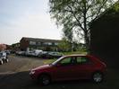 Buffins: houses with large windows.
Tree and grass area on the right.
Parked cars.