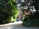 Clent House.
Brick-built at ground floor level, and hung with red clay tiles above.
Tiled roof.
Gravel drive with hedges and trees on each side.
Car parked in drive.