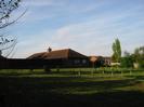 Field with newly-planted trees.
Long low building with dark tile roof is now a house, but was built as the winery for Taplow Vineyard.