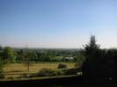 Looking south from the top of Taeppa's Mound.
Hedge and gardens in the foreground.
Part of the Jubilee River in the background.