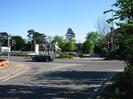 Road Junction, looking south across the Bath Road.
Car dealership on far side of road.
Traffic lights.
Railway embankment in the distance.