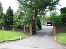 Driveway to Cedar House.
Grassy banks and fences each side.