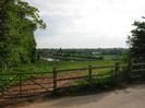 Gate and low fence with field behind.
Field slopes down to Jubilee River in the background.