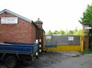 Low brick building with sign:
"MAIDENHEAD SEA CADETS / T.S. IRON DUKE"
Yellow gates to old gasworks site.