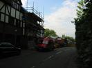 Three-storey houses on left have part-timbered upper levels.
Low brick building in the distance is TS Iron Duke.
Dark trees on right.