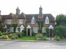 Church Cottages.
Row of cottages built from sandy-coloured bricks with decoration in red brick.
Diamond-leaded windows.
Date AD 1853 set into wall in red brick.
Gardens with grass and low shrubs.