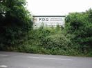 Embankment with bushes.
Sign advertising P.D.Q. Motorcycle Developments.