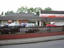 Car showrooms and forecourt of Station Garage Taplow.
Signs advertising Morgan and Mitsubishi vehicles.
Cars on forecourt.
Fence and low wall.