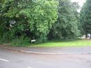 Pavement, grass, and trees.
Road-name sign for Hillmead Court.