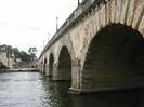 Maidenhead Bridge. Bridge built of sandy stone, with stone balustrade and iron streetlamps along the parapet.
Part of Thames Riviera Hotel on left.