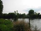 River Thames at Maidenhead Bridge.
Trees on both banks.
Small cabin cruiser moored to near bank.
Large house on far bank.