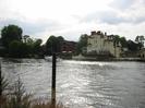 Looking west across the River Thames just below Maidenhead Bridge.
Mooring post on near bank.
Large trees and hotel buildings on far bank.