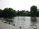 River Thames at Maidenhead.
Concrete quay on left, with two geese on pontoon.
Guards Club Island with large trees.
CHANNEL sign pointing left.
Large black and white house on far bank with red tiled roof.