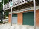 Maidenhead Rowing Club.
Roller-shutter doors leading to boathouse.
Spiral iron stairway on left to balcony.
Coat of arms with crossed oars.