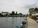 River Thames at Maidenhead Bridge.
Thames Riviera Hotel on left.
Bridge in centre with trees beyond.
Boats tied up along quay.
Maidenhead Rowing Club building on right.