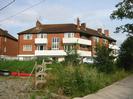 River Court flats 7-12.
Car-park with racing boat and boat-rack in foreground.