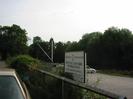 Maidenhead Rowing Club car-park.
Cars and old boatyard crane in distance.
Rowing Club sign.
River Thames on right.