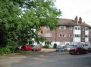 Bridge Court flats.
Trees on left.
Parked cars.