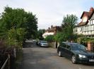 Looking north on River Road.
Overhanging trees on the left.
Parked cars on road.
River Court flats in the distance.
Cornerways and Yew Tree Cottage on the right.