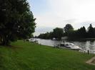 River Thames with boats moored along grassy bank.
Trees on left and on far bank.